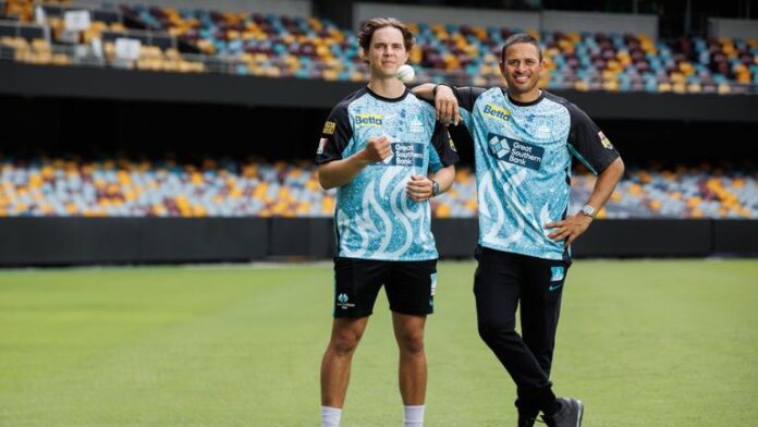 Brisbane Heat players Mitch Swepson and Usman Khawaja at the Gabba before their opening round game against the Melbourne Stars. Picture Lachie Millard Source- News Corp Australia