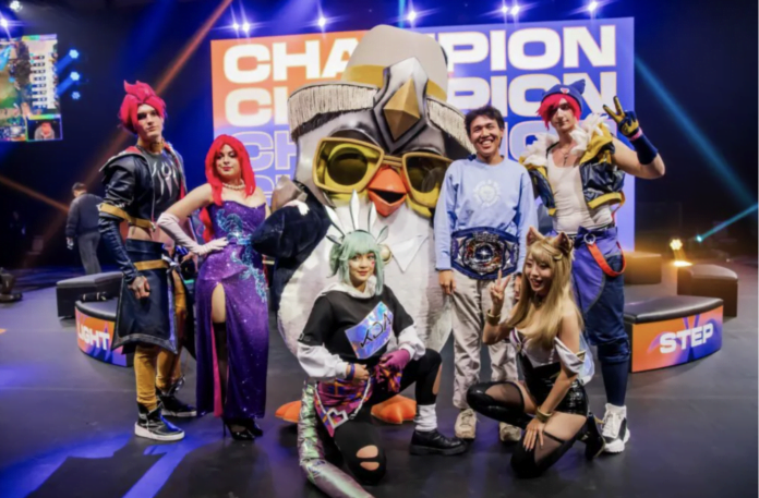Milala-with-his-TFT-Vegas-Open-champions-belt-alongside-cosplayers-and-Pengu-Image-via-Riot-Games